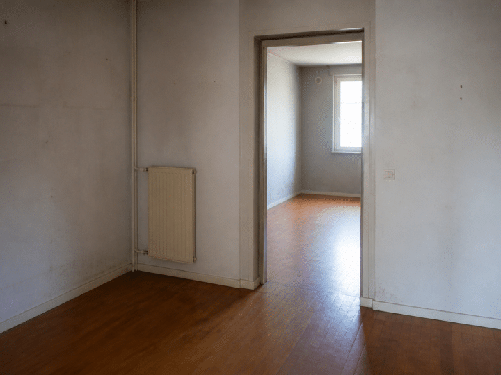 Appartement HLM vide avec murs nus et usures visibles