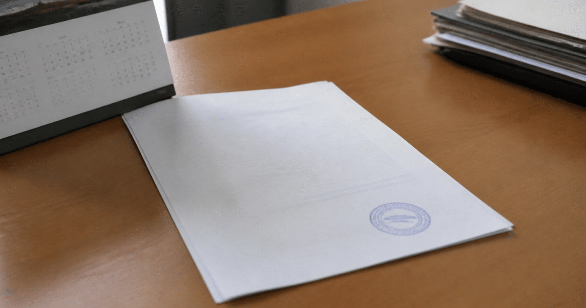 Document officiel tamponné posé sur bureau avec calendrier